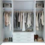 A neatly organized dressing unit with dresses hung in an orderly fashion.