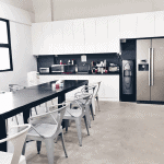 A modular kitchen integrated with a dining area.