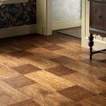 A wooden floor featuring a checkered design pattern.