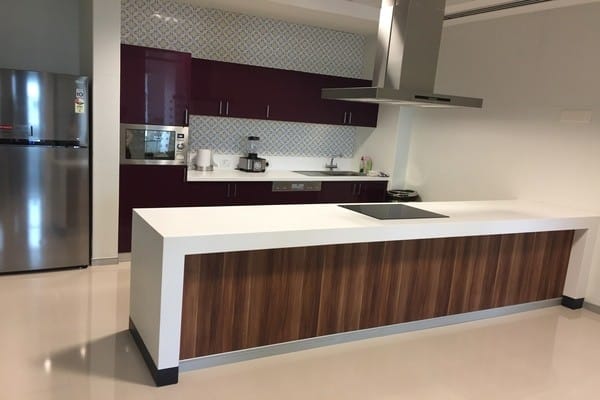 A wooden kitchen island counter-top with a sleek, polished finish and natural grain.