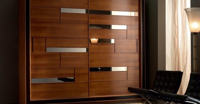 A picture of a wooden wardrobe featuring trendy mirrors and a stylish design.