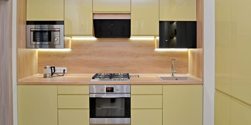 A well-maintained modular kitchen featuring contemporary storage with a tidy design.