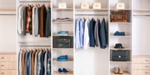 A well-organized wardrobe displays clothes and essential storage fittings.