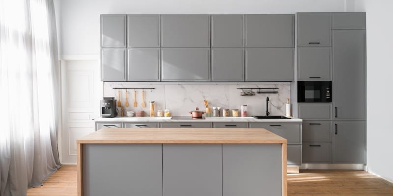 A clean & neat island kitchen highlights it's advantages and disadvantages.