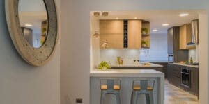 A small open kitchen in an apartment, showing countertops, cabinets, and basic appliances.