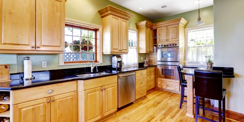 A modular kitchen with wooden finish cabinets.