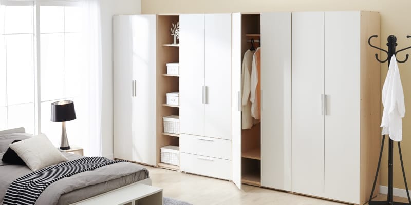 A modern white wardrobe in the bedroom, made from premium material with a sleek finish.